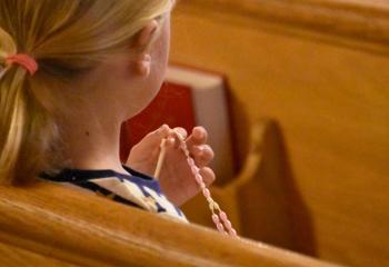 Charlotte Harpster prays the rosary during the Holy Hour at Assumption BVM. (Photo by John Simitz)