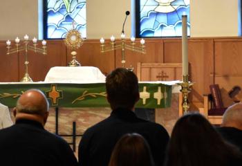 Clergy and faithful join together in adoration at Assumption BVM, Bethlehem. (Photo by John Simitz)