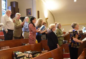 The Holy Rosary Choir sings a Marian hymn during Mass.