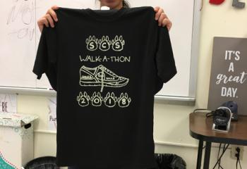 Evelyn Nguyen displays the shirt she designed for the project.