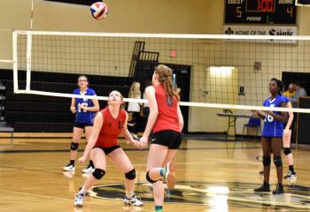 Kylie Heinze, left, prepares to receive a set from her teammate from St. Thomas More, Allentown. 