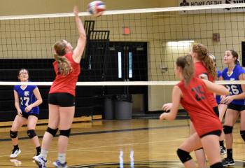 Heinze tips the ball over the net during St. Thomas More’s championship match against OLPH.
