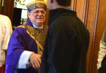 Bishop Schlert meets a parishioner after the liturgy.