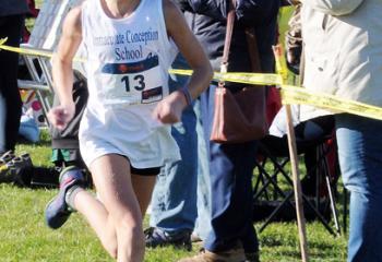 Olivia Schweitzer, Immaculate Conception BVM, Allentown, runs to the finish line to be the first girl to win the seventh- and eighth-grade boys’ and girls’ race.