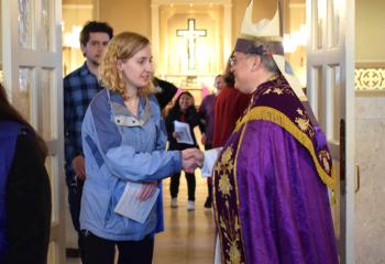 Bishop Schlert greets Erin Trautmann, parishioner of St. Joseph the Worker, Orefield, after the service.