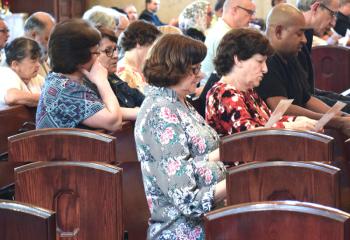 Participants pray the Healing Prayer during a wrap-up meeting in Spanish May 23 at the Cathedral of St. Catharine of Siena, Allentown.