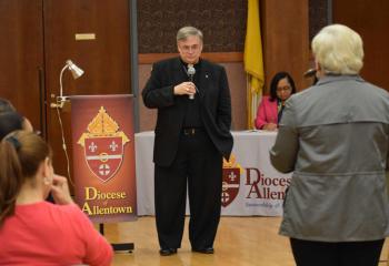 Bishop Schlert responds to questions at the meeting at the Cathedral.