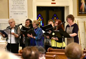 Choral members of Sacred Heart, Bath provide music for the Mass.