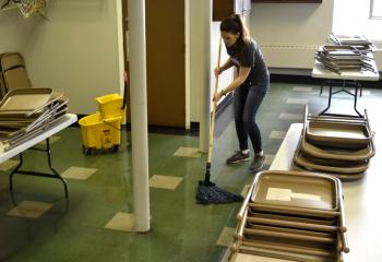 Laurel Ross mops the main lunch room. The kitchen operates Friday through Sunday 12:30 to 1:30 p.m.