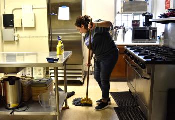 Dalia Shehata cleans up the kitchen. Clients were not at the Ecumenical Kitchen that day during the cleanup.