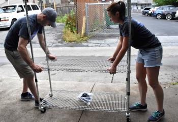 Eric Staub, left, and Magen Verholy build new shelves as volunteers work to spruce up the site. 