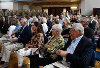 Supporters listen to remarks during the Promotion Ceremony.