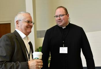 Father Eugene Ritz welcomes the speaker Deacon Greg Kandra. 