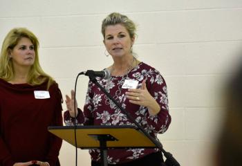 Michele Mullikin, left, director of parish stewardship and annual giving, and Ginny Downey, major and planned gifts officer, discuss the mission of the society.