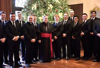 Seminarians gathered with Bishop Schlert, center, and Father Christopher Butera, right, director of seminarian formation, are from left: Philip Mass, Keaton Eidle, Miguel Ramirez, Robert Rienzo, Deacon Juan Eduardo Rodriguez, Tyler Loch, Kolbe Eidle, Aaron Scheidel, Matthew Kuna, Anh Do Mai, James Hy Ngô and Alexander Brown. 