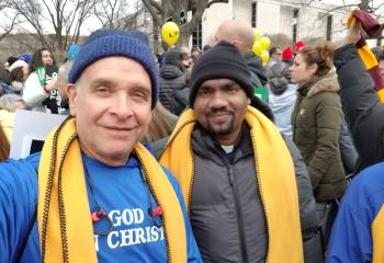 Also on the St. Jane bus are Freddie Melendez from Our Lady of Perpetual Help Parish, Bethlehem, left, and Father Alex Anthony, assistant pastor of Holy Family Parish, Nazareth. (Photo courtesy of Andrew Azan III)
