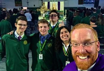 Father Mark Searles, school chaplain, right, with some of the students participating in the Jan. 22 Mass at Allentown Central Catholic High School, from left, Alan Garger, John Fenstermacher, Gavin Drake and Wilma Taveras. (Photo courtesy of Father Mark Searles)