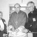 Bishop Cullen cuts the ribbon during the dedication ceremony for the Lehigh-Northampton Counties Office of Catholic Charities, Sept. 8, 1999. Joining him is Barbara W. Murphy, Secretary for Catholic Human Services, and the Rev. Msgr. Joseph E. Kurtz, then director of Catholic Charities.