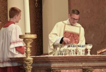 For the first time Deacon John Hutta prepares the gifts for the Holy Sacrifice of the Mass. (Photo by John Simitz)
