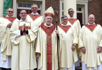 Gathering after the Mass are, from left, Msgr. Francis Schoenauer, Deacon John Hutta, Msgr. Gerald Gobitas, Bishop Edward Cullen, Msgr. Alfred Schlert, Father Christopher Cooke and Msgr. David James. (Photo by John Simitz)