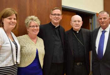 Deacon John Hutta, center, gathers after the Mass with, from left, his sister JoLynn Shelton, his mother Diane Hutta, Bishop Edward Cullen and his father John Hutta. (Photo by John Simitz)