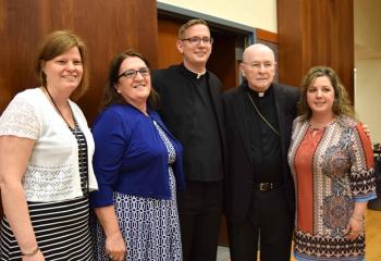 Gathering with Deacon Hutta after the Mass are, from left, JoLynn Shelton, his stepmother Cindy Klein, Bishop Cullen and his sister Vanessa Klein Lesniak. (Photo by John Simitz)