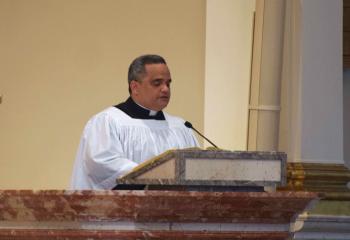 Seminarian Juan Rodriguez serves as lector for the first reading. (Photo by John Simitz)