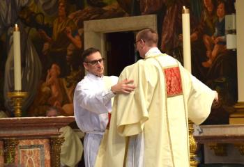 Deacon Edward Girard vests Deacon John Hutta with stole and dalmatic. (Photo by John Simitz)