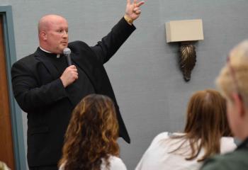 “We have to be invested in one another as Christ is invested in us,” Father Allen Hoffa says during the evening presentation. (Photo by John Simitz)