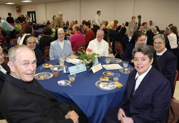 Msgr. Joseph Smith, pastor emeritus of St. Catharine of Siena, in residence at St. Joseph the Worker, Orefield, left, enjoys the luncheon with IHM sisters, from left, Sister Joanne Wallace, Sister Honoria Smith, Sister Helene Thomas, Sister Catherine Danielle, Sister Bernadette Kane, Sister Jane Mary Carr and Sister MaryEllen Tennity. . (Photo courtesy Sister Teresa Ballisty)