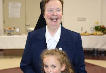 Sister Bernadette Kane, former teacher at St. Catharine of Siena School, greets Lydia Fries at the luncheon. . (Photo courtesy Sister Teresa Ballisty)