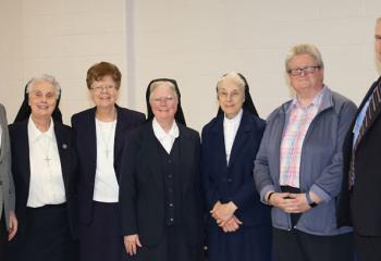 Gathering at the reception are, from left: John Bakey, diocesan chancellor of Catholic education; Sister Kathleen Metz; Sister Anita Patrick Gallagher, assistant superintendent elementary schools and early childhood education; Sister Teresa Ballisty; Sister Barbara Bussinger; Alexandria Cirko, assistant superintendent religious education; and Dr. Philip Fromuth, diocesan superintendent of Catholic education. . (Photo courtesy Sister Teresa Ballisty)