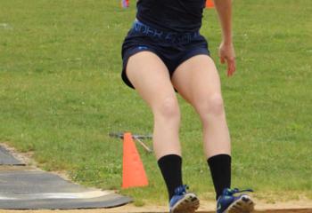 Carissa Peck, Holy Family, Nazareth, executes the long jump and clinches first place in the event.
