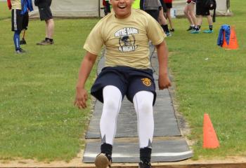 Tyriek Rivera, Notre Dame of Bethlehem, descends for his landing while competing in the long jump. 