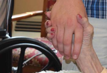 A Holy Family Manor and Quo Vadis participant share a handshake. (Photo by John Simitz)