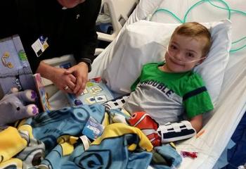 Deacon Francis Elchert, assigned to St. Elizabeth of Hungary, Pen Argyl, delivers a package from Amber’s Packages of Love to a patient at Children’s Hospital of Philadelphia.