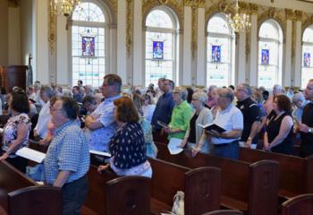 The concert audience joins the choir in singing “Sing of Mary” at the cathedral.