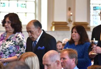 Presenting the offertory gifts are, from left, Julio and Paul Perez, and James and Diane McCawley.