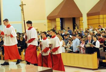 Altar servers lead the procession at St. Jane, the home parish of Bishop Schlert. “After 30 years in the priesthood, I would not give back one day – not one – even though they weren’t all easy. It’s a beautiful life,” said Bishop Schlert. Altar servers are, from left, Peter McKeon, Nicholas Zambo, Anthony DeMasi and Brian Myers.