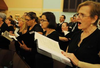 Members of the Combined Choir from parishes in the Northampton Deanery sing a hymn during Mass. More than 90 choir members joined together to perform musical selections at the first of five deanery Masses to be celebrated by Bishop Schlert.