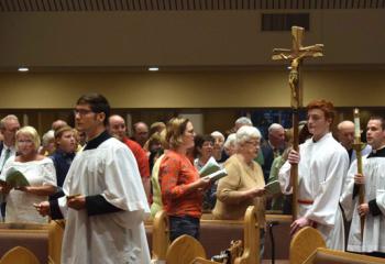 The faithful sing the processional hymn. One of the laity commented about Bishop Schlert after Mass, “He is like St. John Neumann – the people’s Bishop.’”