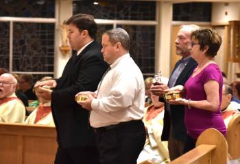 Presenting the offertory gifts are, from left, Dr. Jeff Leoni, John Jolls, Greg Calabria and Kathy Hessler.