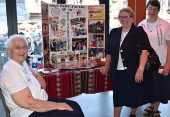 Religious sisters display information on the Missionary Sisters of the Most Sacred Heart of Jesus (MSC). (Photo by John Simitz)