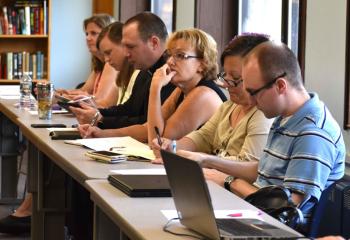 High school representatives listen to Wallace, from left, Debra DeSanto, Kathleen Rasley, Father Christopher Butera, Sharon Hillhouse, Elizabeth Grys and Daniel Lisella.