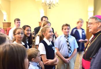 Bishop Alfred Schlert greets school children from St. Joseph the Worker, Orefield.