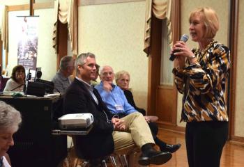 Bill Donaghy, left listens as Mary Fran Hartigan, secretary of the Diocesan Secretariat for Catholic Life and Evangelization and director of the Office of Adult Formation, welcomes those gathered. Rick Dooley, assistant director of the Office of Adult Formation, also attended. 