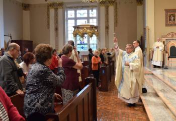 Bishop Schlert blesses the faithful with holy water from Fatima.