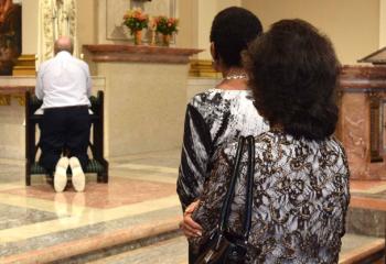 Faithful line up to offer a prayer for the intercession of Our Lady of Fatima.