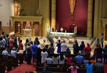 Mothers lead a decade of the rosary before the Eucharist at St. Elizabeth. (Photo by John Simitz)