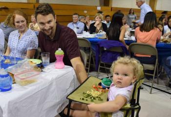 Enjoying the festivities at St. Elizabeth are, from left, Megan, Mark and Rose Quaranta, parishioners of St. Thomas More, Allentown. (Photo by John Simitz)